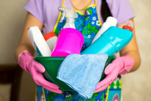Kitchen cleaning service with counters, sinks, and appliances being wiped down