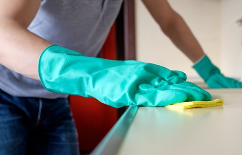 Commercial cleaner sanitizing office surfaces
