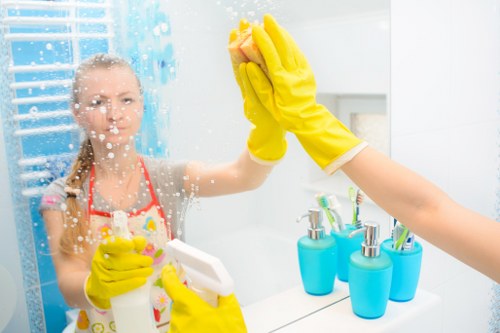 Cleaners detailing glass panels for a bright finish